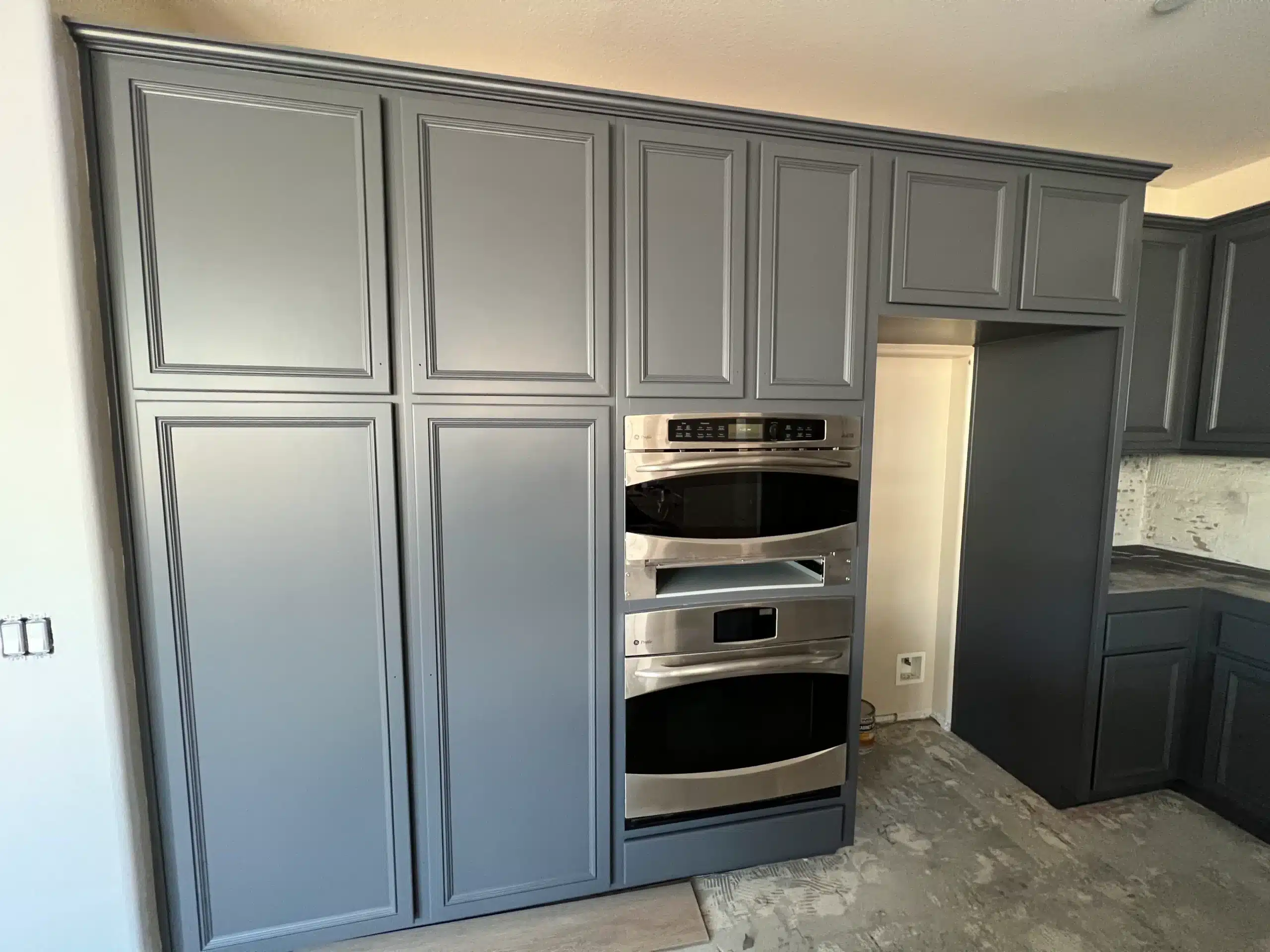 Custom Kitchen Cabinet Painting in Simi Valley California Tall grey kitchen cabinets installed next to a double oven, part of a remodel in Simi Valley California.