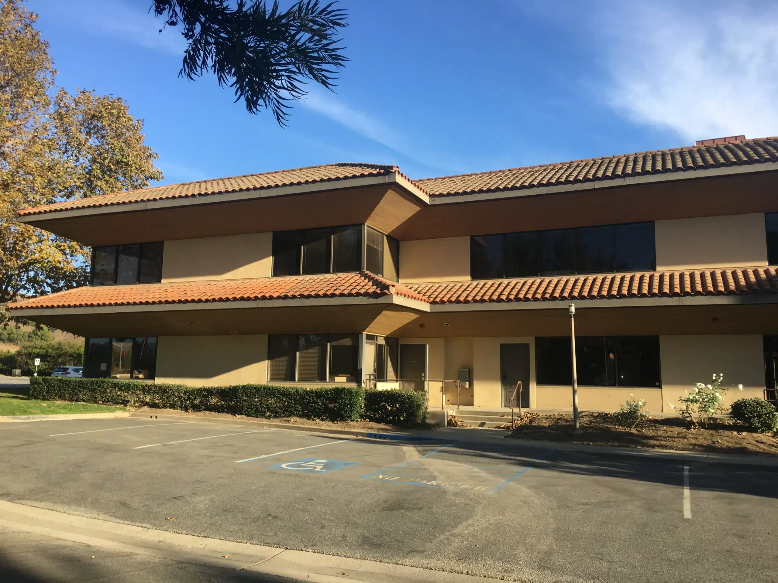 Commercial Exterior Painting Simi Valley California Two story commercial building with tan walls and red tile roof for exterior painting in Simi Valley California.