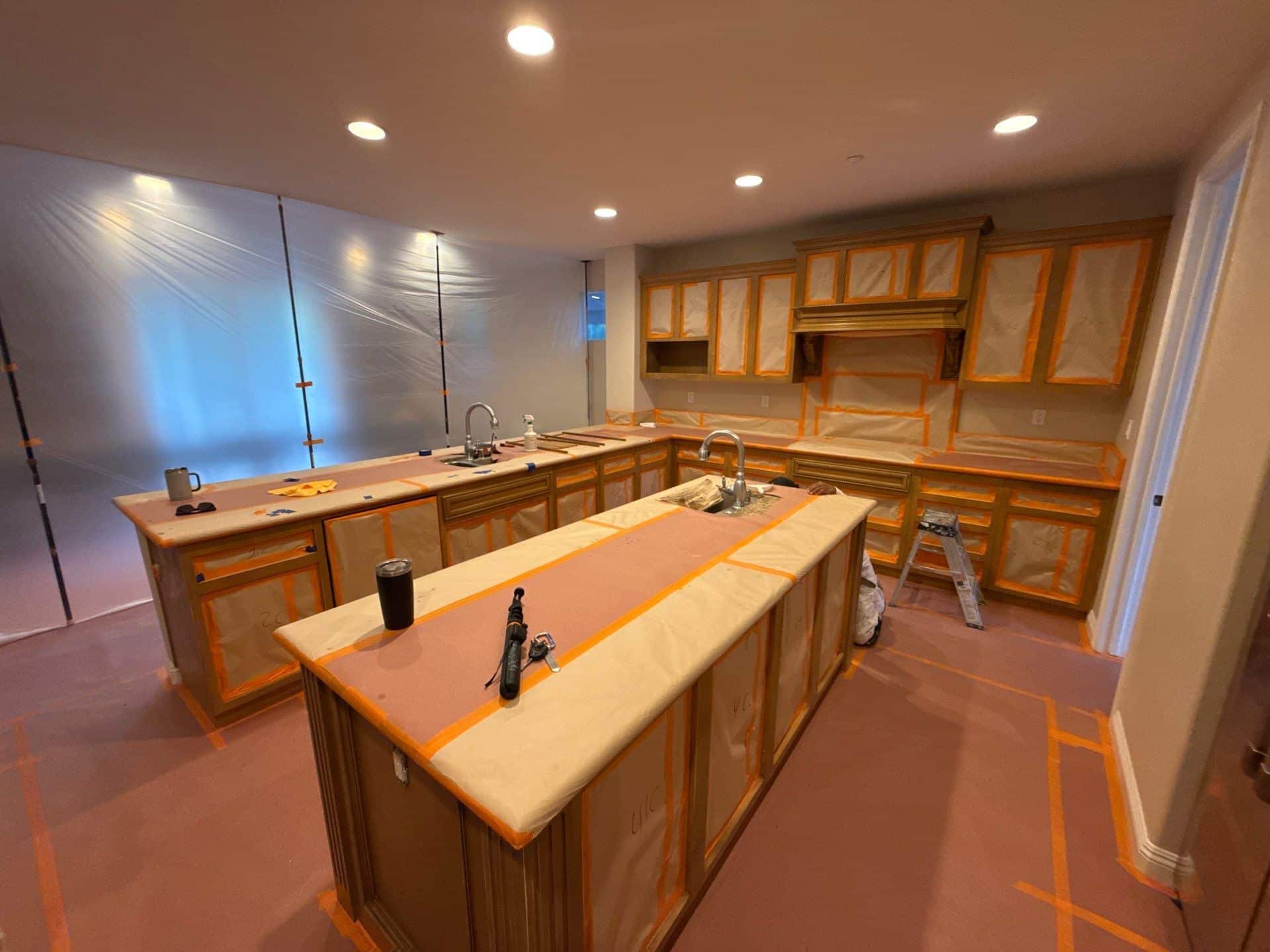 Walnut Kitchen Cabinets Refinishing Walnut-stained wooden kitchen cabinetry with center island, granite countertops, and recessed ceiling lighting during